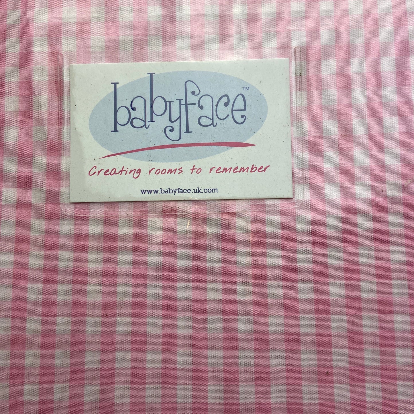 Pink and white checkered fabric with a 'babyface' label.