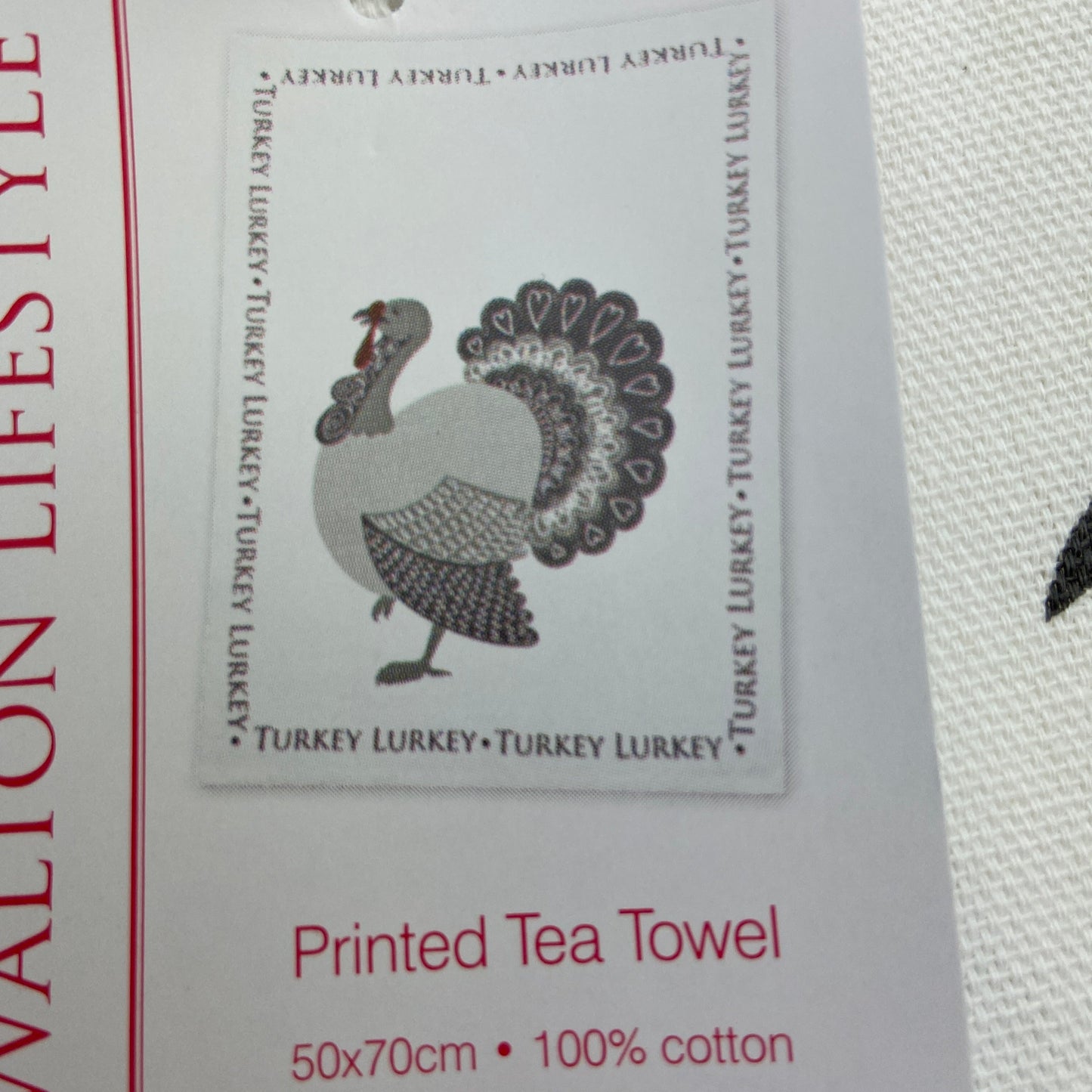 Printed tea towel with a turkey design and text on a white background