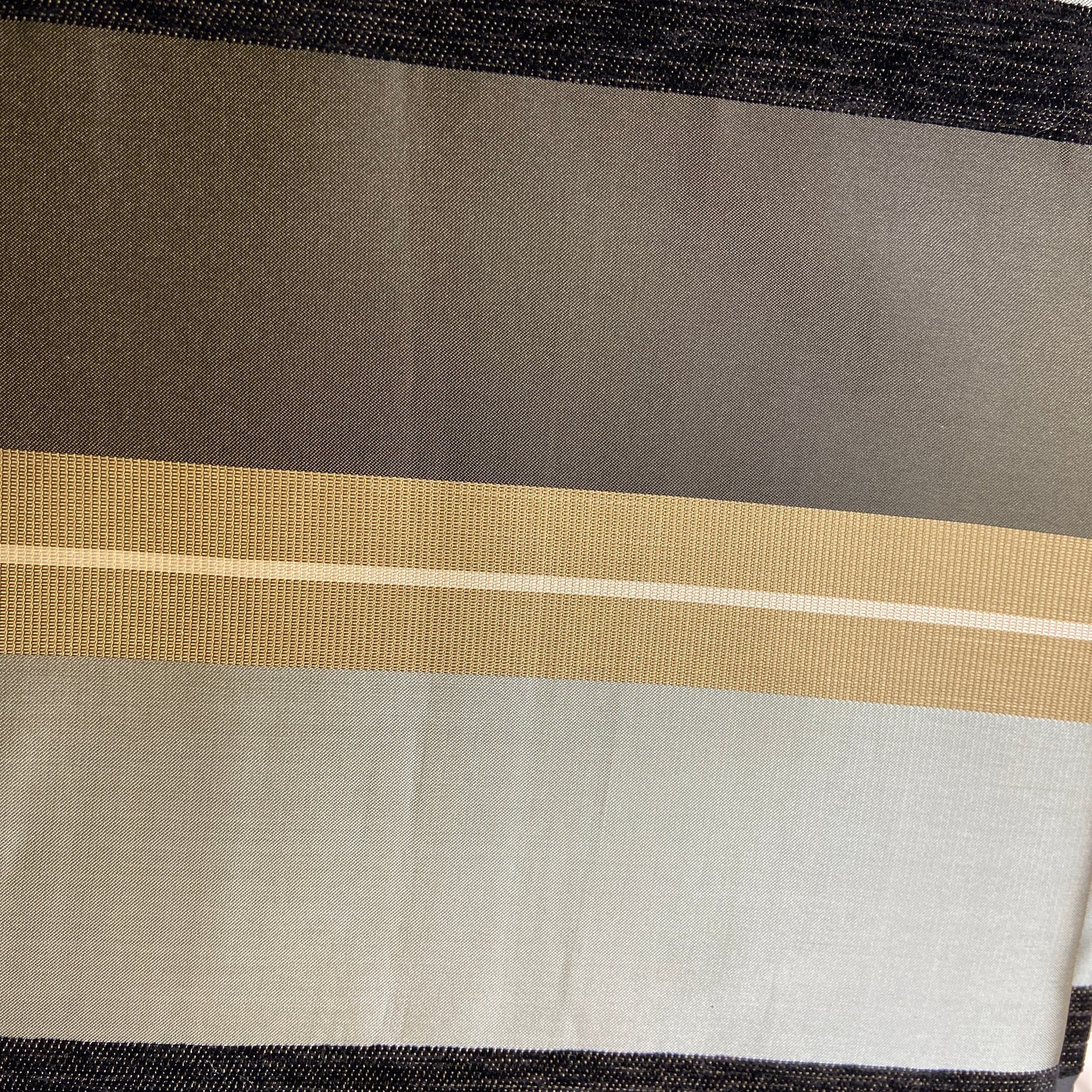 Close-up of a fabric with striped pattern on a neutral background