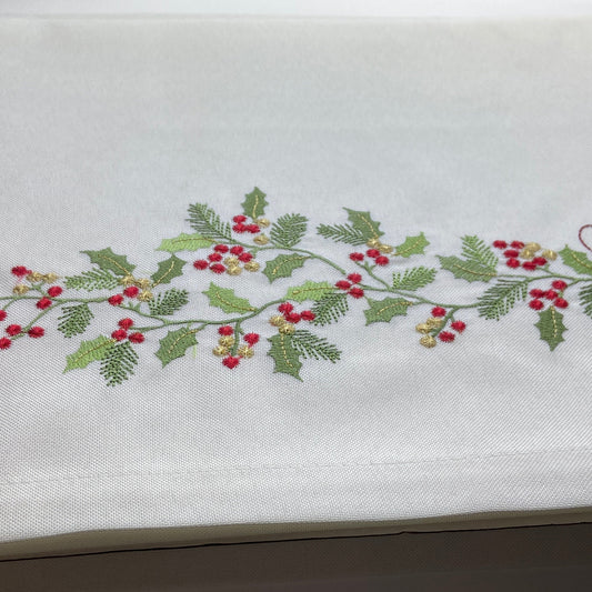 Embroidered holly design on a white fabric background