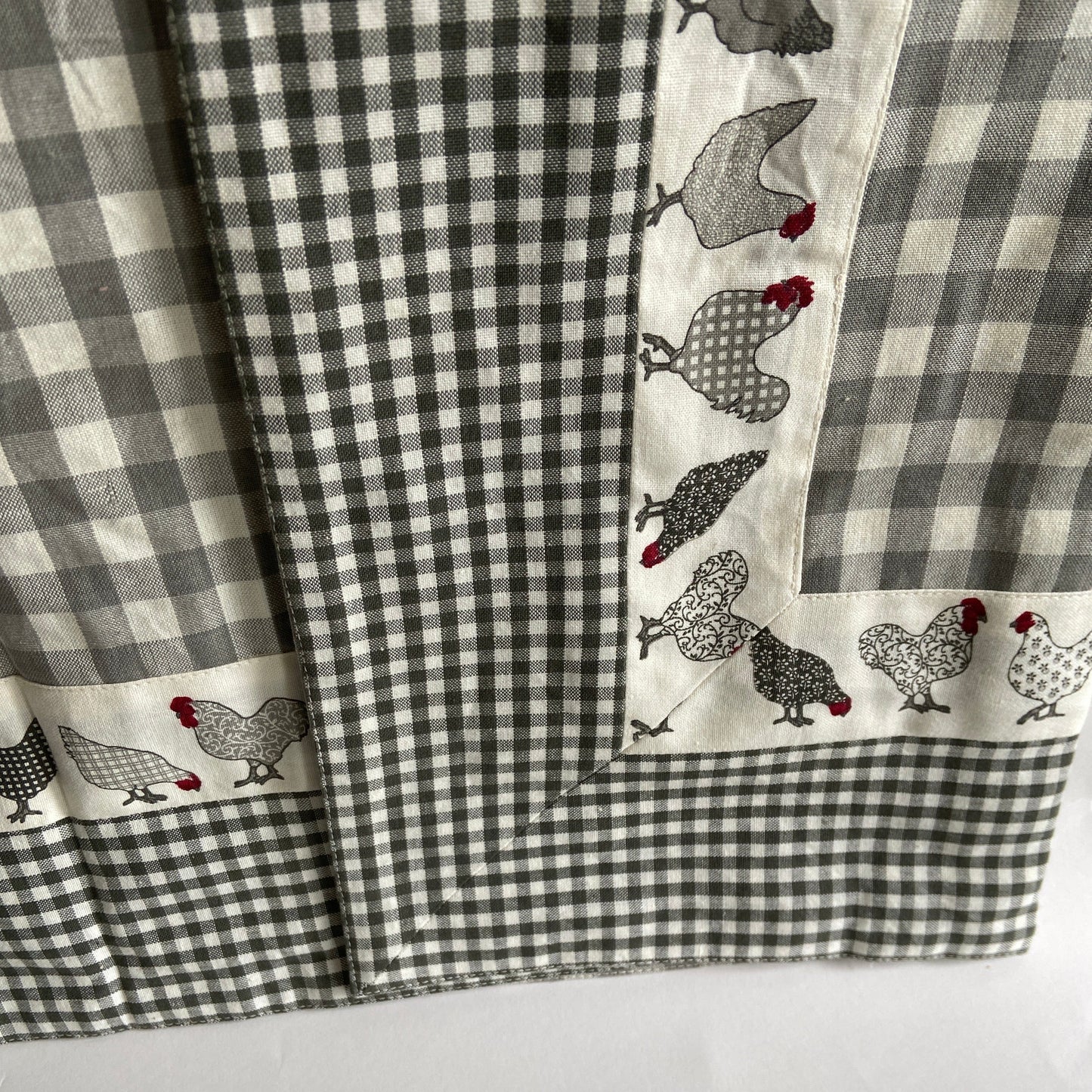 Checkered fabric with chicken pattern on a gray background