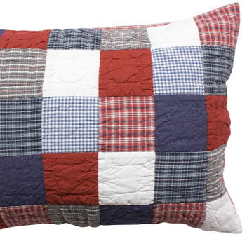 Patchwork pillow with red, blue, and white plaid patterns on a white background