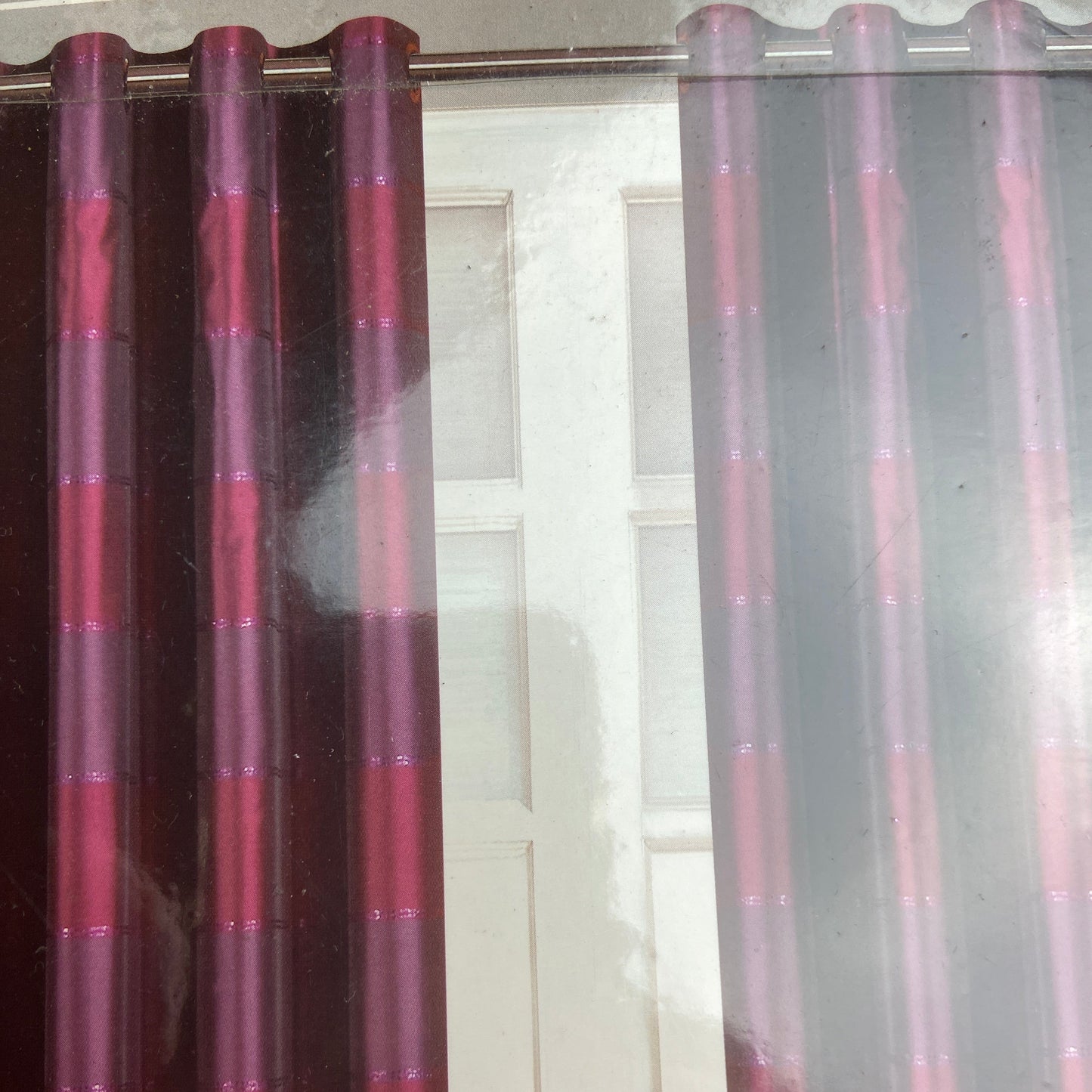 Manhatten Aubergine Eyelet Curtains by Belfield Furnishings. These fully lined curtains featuring stripes running across in a deep aubergine and deep pink and deep pink metallic lines. Face 100% polyester, Lining 50% polyester 50% cotton.