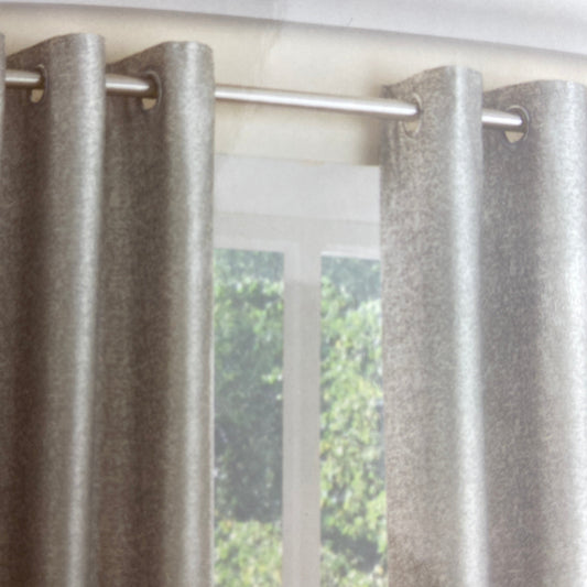 Luna Silver Eyelet Curtains by Belfield Furnishings. One pair of fully lined eyelet curtains featuring a shimmering silver design set on a grey background. Face & Lining 100% polyester.