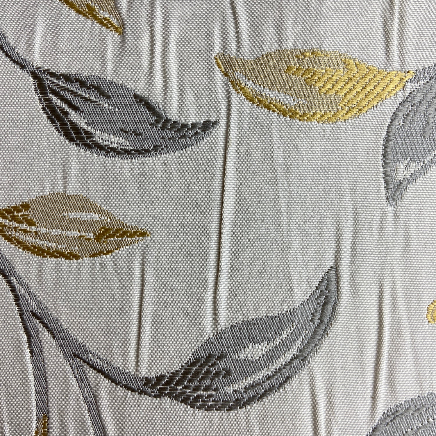Close-up of fabric with leaf pattern on an ivory background