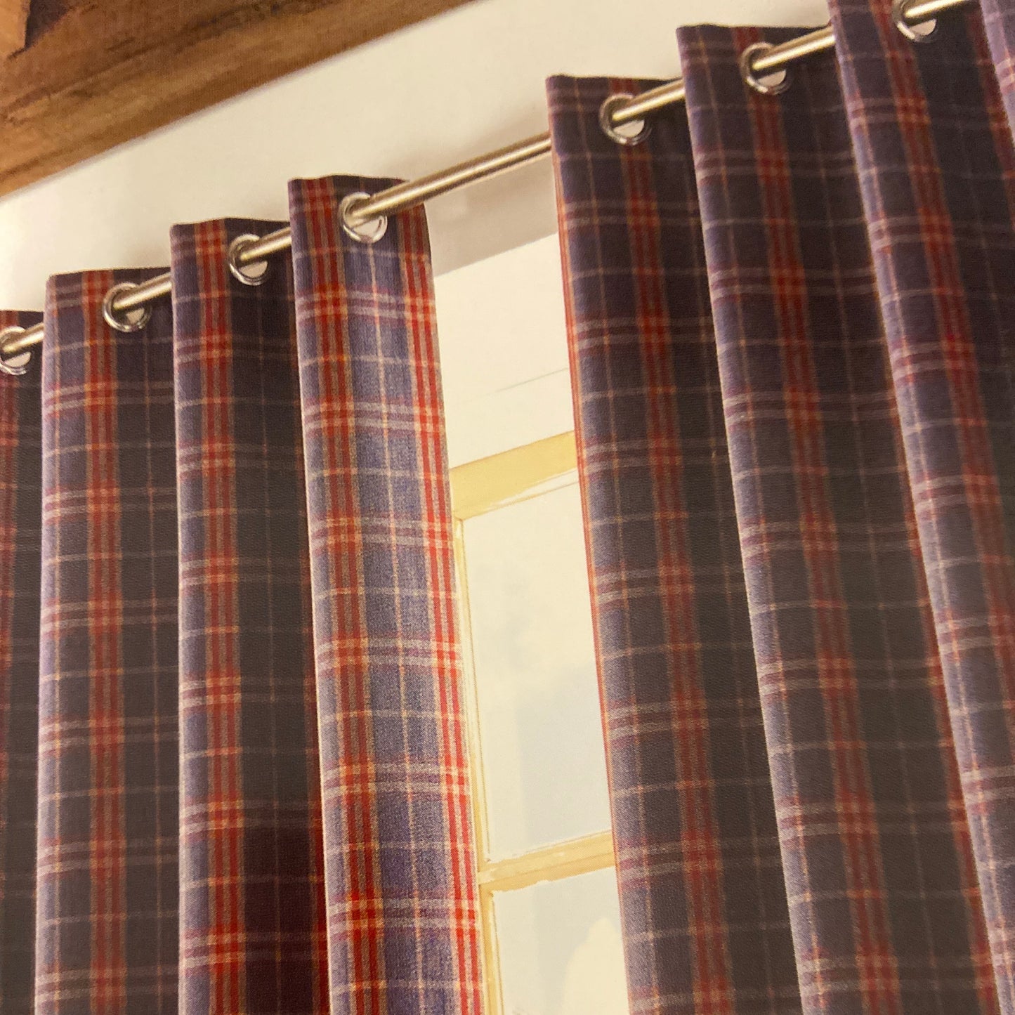 Archie Eyelet Curtains by Ashley Wilde. These fully lined check design curtains are available in denim blue or red. Face 100% polyester, lining 80% polyester 20% cotton.