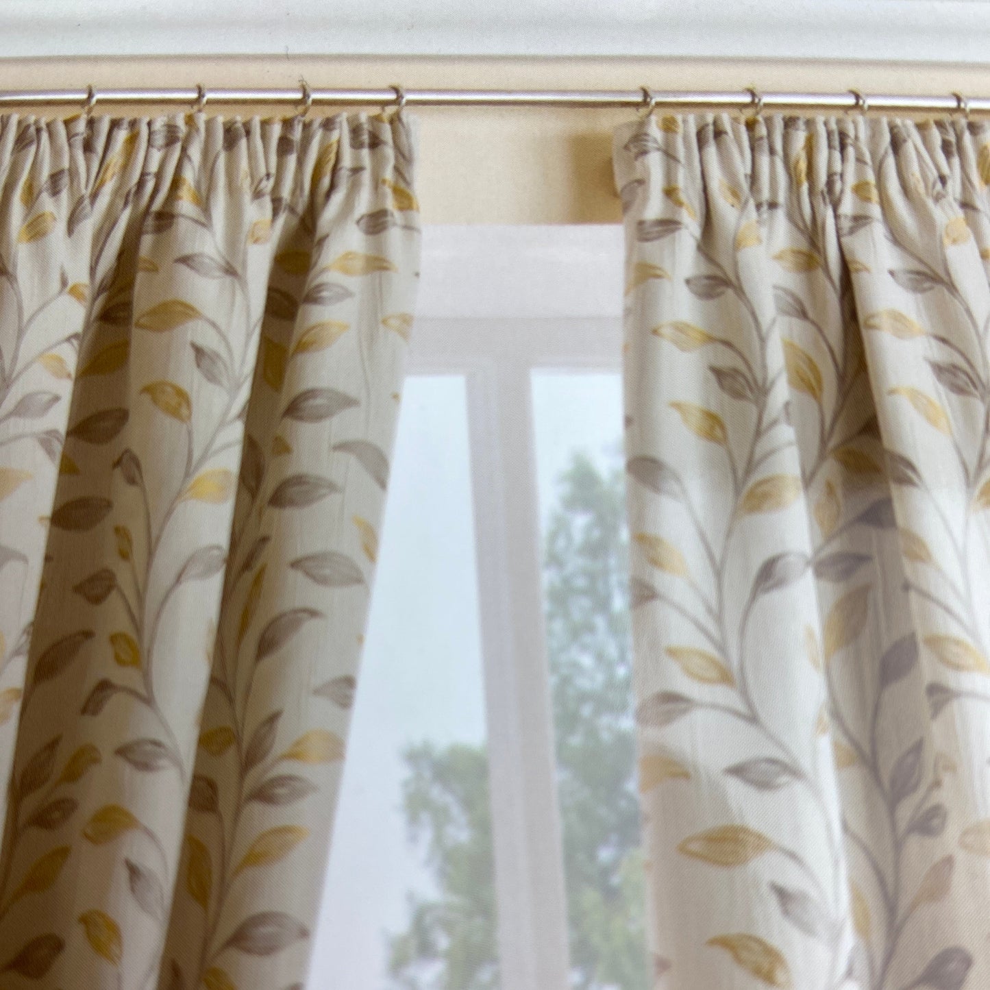 Pencil Pleat curtains in ochre & grey leaf print
