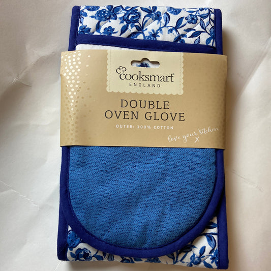 Blue oven glove with floral pattern packaging on a white background