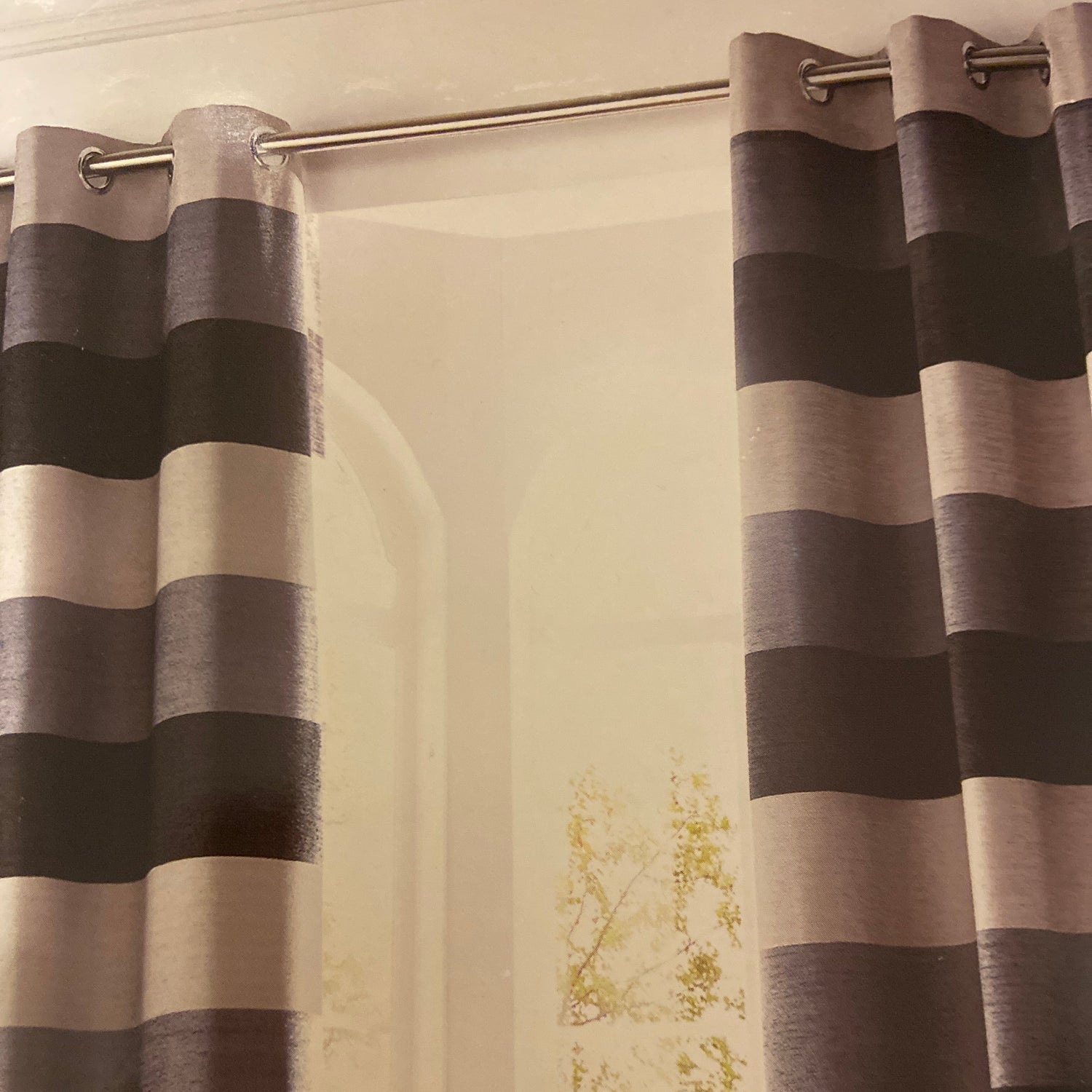 Bromley Eyelet Curtains by Ashley Wilde. These fully lined eyelet curtains in chenille with dark slate, grey and light grey broad stripe design. Face and lining 100% polyester.