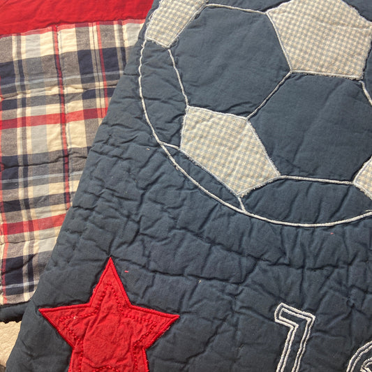 Quilt with red star and plaid pattern, featuring the number 11.