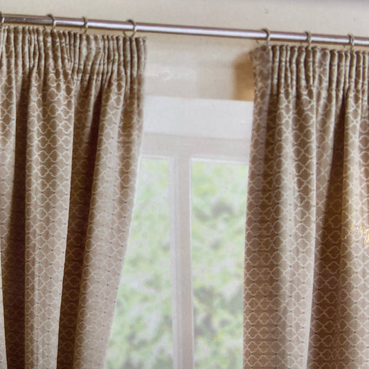 Marrakech Pencil Pleat Curtains By Belfield Furnishings. One pair of fully lined pencil pleat curtains. Available in Pewter, Natural or Spice in colour with an embroidered design. 100% polyester face and lining.