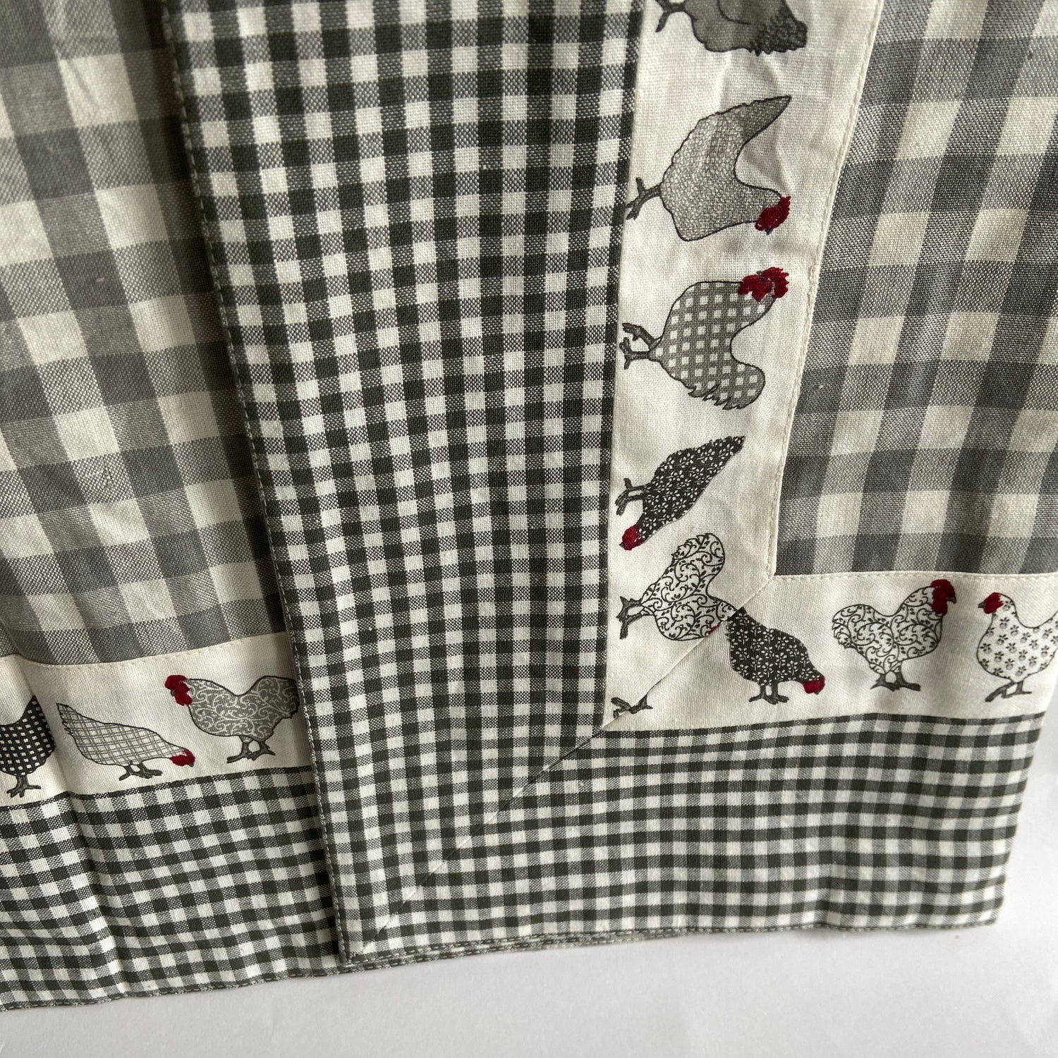 Checkered fabric with chicken pattern on a gray background