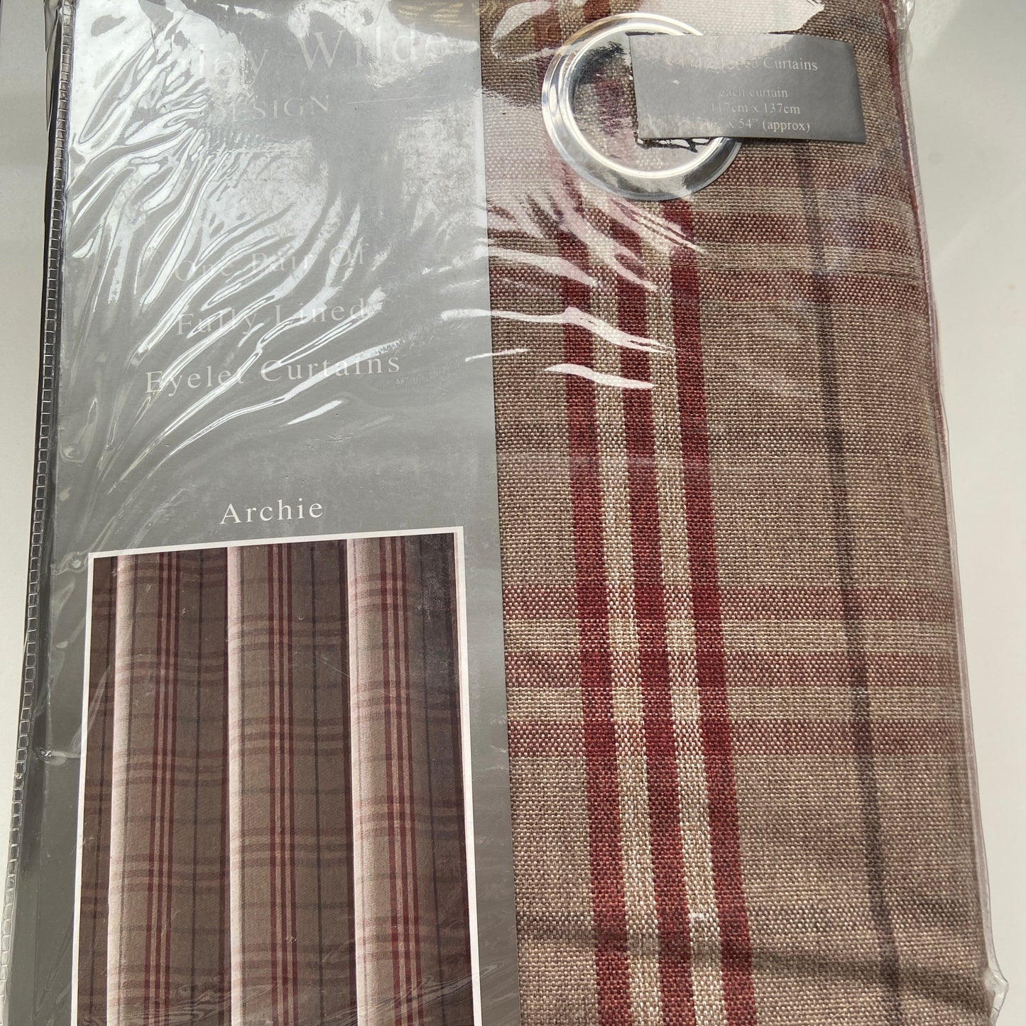 Packaged curtain with striped pattern and Arched brand label.