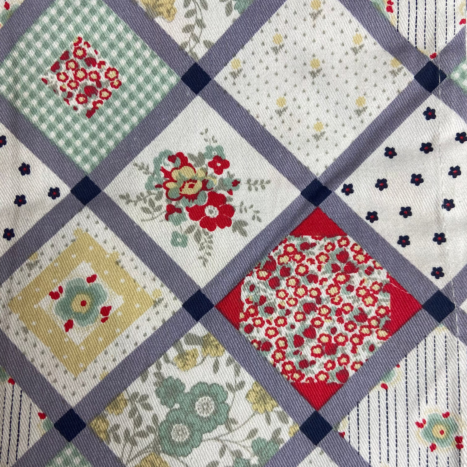 Tea Towel with patchwork design featuring various patterns and colors, with 'Kirstie Allsopp Home Living' branding.