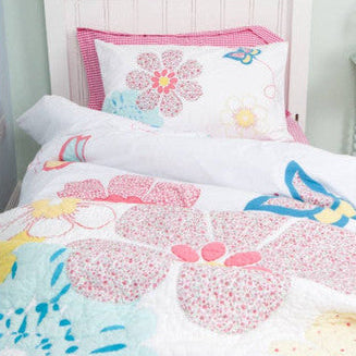 Children's bed with floral and butterfly patterned bedding
